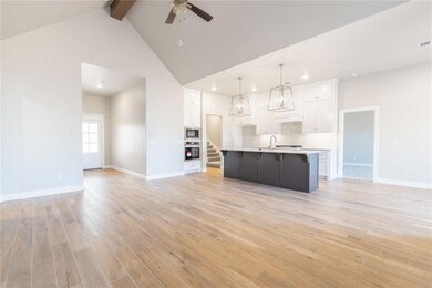 Unfurnished living room with high vaulted ceiling,