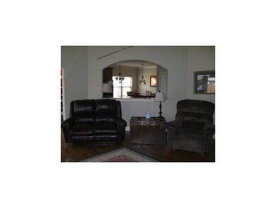 Living Room. Open living room with view to the kitchen as well as dining area.