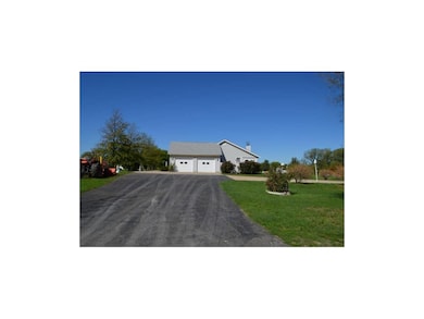 Driveway leading to the two car garage and drive o