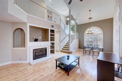 Living room featuring high vaulted ceiling, wood 