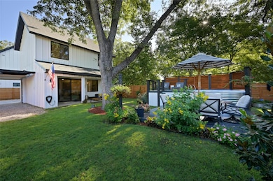 Back of property with a patio area and a shingled