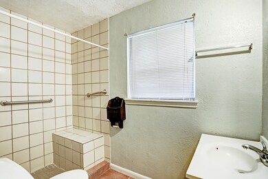 A full secondary bathroom with walk-in shower.
