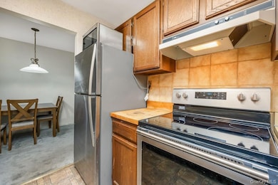 Kitchen stainless steel  appliances  view into dining area