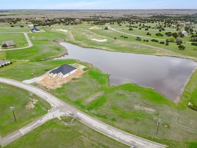 Birds eye view of property with a water view and a