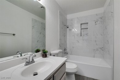 Bathroom featuring vanity, toilet, shower / tub co
