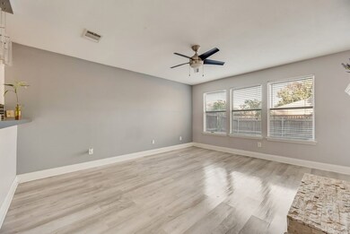 Spare room with light wood-type flooring and a ceiling fan
