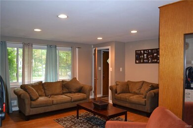 The living room has hardwood flooring and is locat