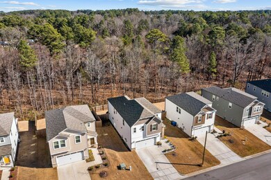 House and wooded area beyond back yard.
