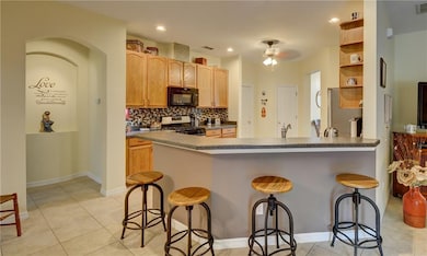 Breakfast bar and kitchen. Master suite at left.