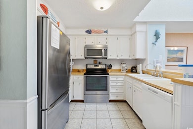 Kitchen with stainless steel appliances, a sink, a