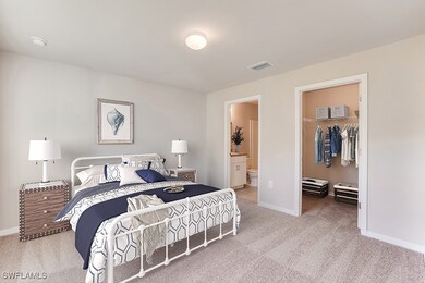 Bedroom with carpet flooring, a spacious closet, b