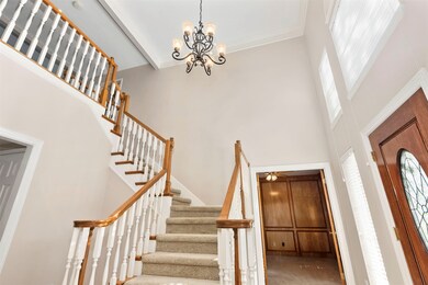 The stairs are the perfect accent as you enter the home.  The elegant light fixtures enhance the space and the windows allow ample soft light to flow into the front.