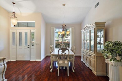 The flooring in the entry, dining room and living 