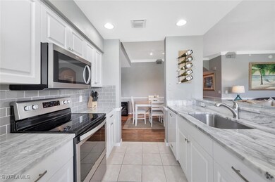 Kitchen with stainless steel appliances, a sink, w