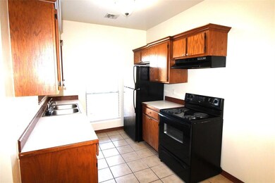 Kitchen featuring sink, black appliances, and ligh