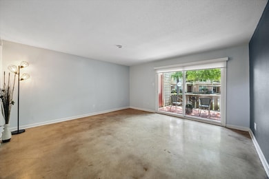 Spacious living room, featuring a large sliding gl