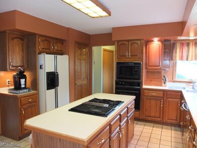 Spacious kitchen with pantry, countertop range and grill top and wall oven.