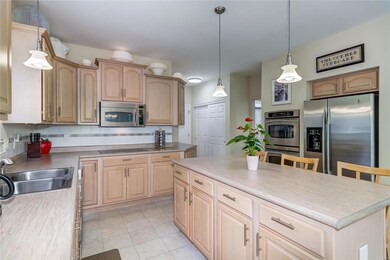 The kitchen offers custom cabinets, stainless stee