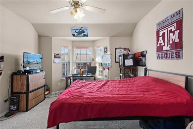 Carpeted bedroom featuring vaulted ceiling
