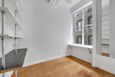 Bedroom featuring wood finished floors and a ceiling fan