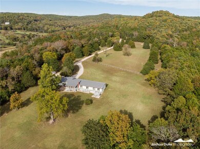 Aerial view of house and driveway from lake side.