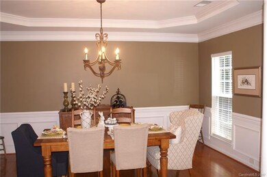 Large dining room with hardwood floors, tray ceili