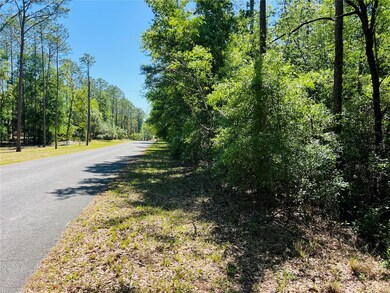 Right Side-View of Property Going East. Nice Elevation With Beautiful Native Trees. 1.78 Acres Located In 