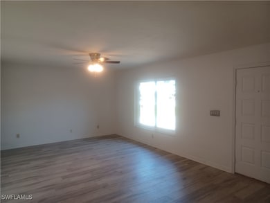 Spare room featuring a ceiling fan, wood finished