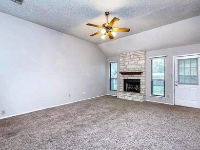 Unfurnished living room featuring ceiling fan, lo