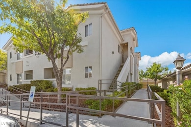 View of side of home with stucco siding and a tiled roof