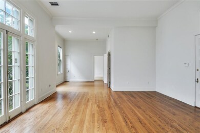Living Room, French Doors looking toward Dining Room and door to Primary Bedroom