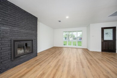 Unfurnished living room featuring baseboards, visi