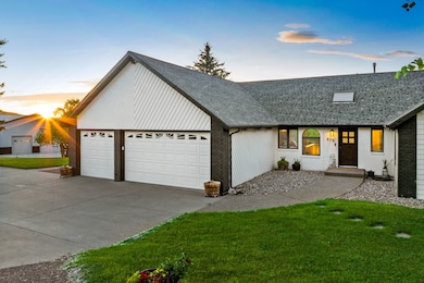 View of front of house with brick siding, a shingled roof, a yard, and concrete driveway