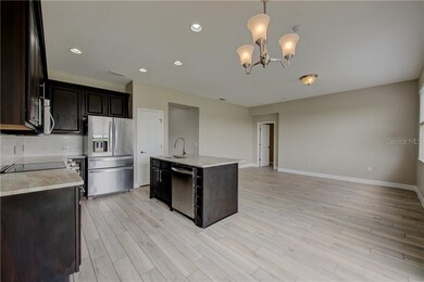 Kitchen features espresso colored cabinets and bea