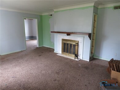 Fireplace flanked by built in bookcases on either
