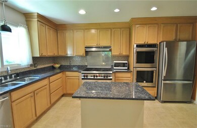 Beautifully updated kitchen has maple cabinets wit