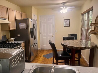 Kitchen featuring under cabinet range hood, gas ra