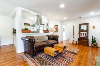 Living room showing opening to updated kitchen