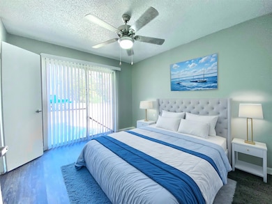 Bedroom with access to exterior, wood finished flo