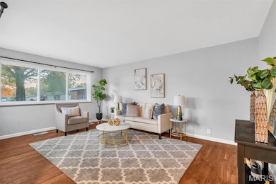 Living room with dark wood-style floors and baseboards