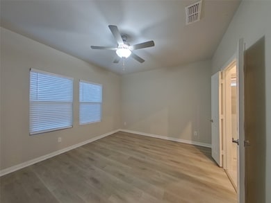 Unfurnished room featuring light wood-style floors and ceiling fan