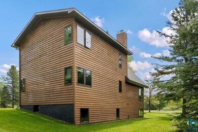 View of home's exterior featuring a yard and a chimney