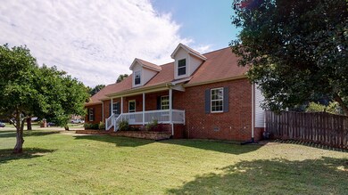 Partially brick home with a covered front porch