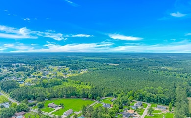 Aerial view of property and surrounding area with 