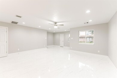 A wide-open living area and dining with bright nat