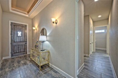 Beautiful Entryway with views all the way to the back of the home. Notice the beautiful tray ceiling.