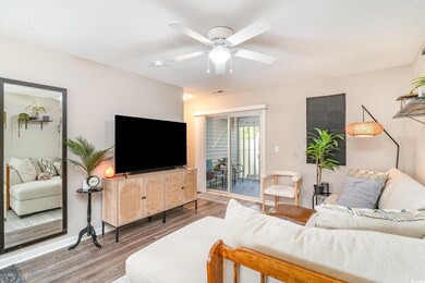Living room with visible vents, wood finished floo