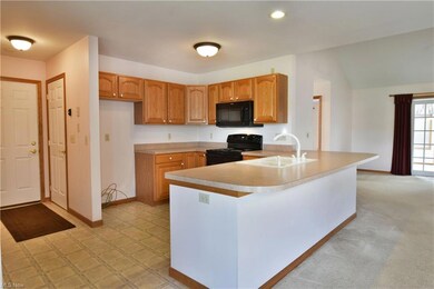 Kitchen featuring light countertops, light carpet,
