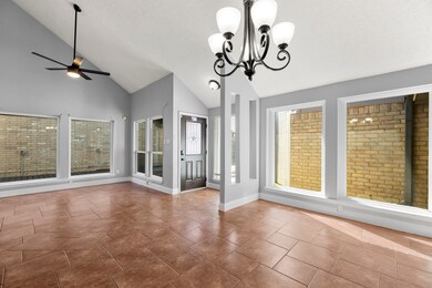 Bright and welcoming space featuring the front entry, new ceiling fan, and abundant windows that fill the area with natural light and create an open, airy feel.