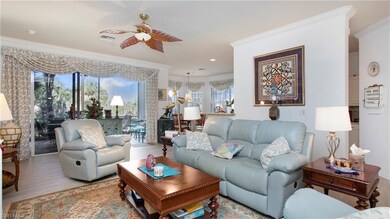 Living room with crown molding, hardwood / wood-st